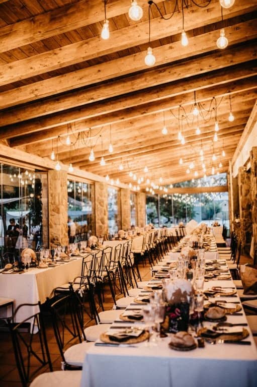 Elegant hotel dining area with rustic wooden ceiling and ambient lighting.