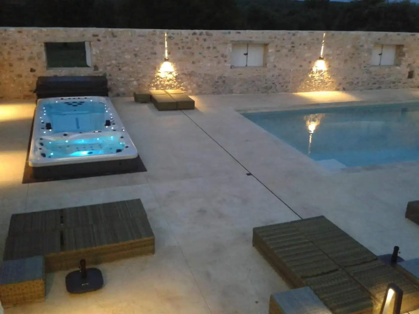 Elegant outdoor pool and hot tub at Domaine de La Quiquier estate in Goudargues, France.