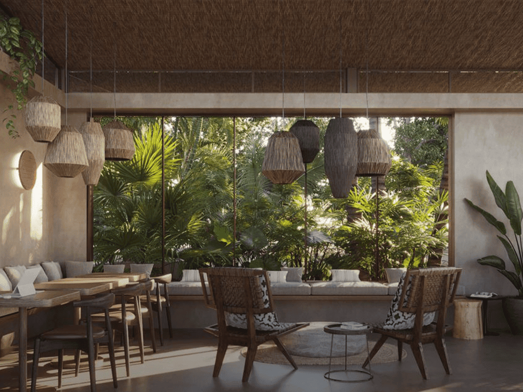 Comfortable indoor lounge with large windows and lush greenery view.