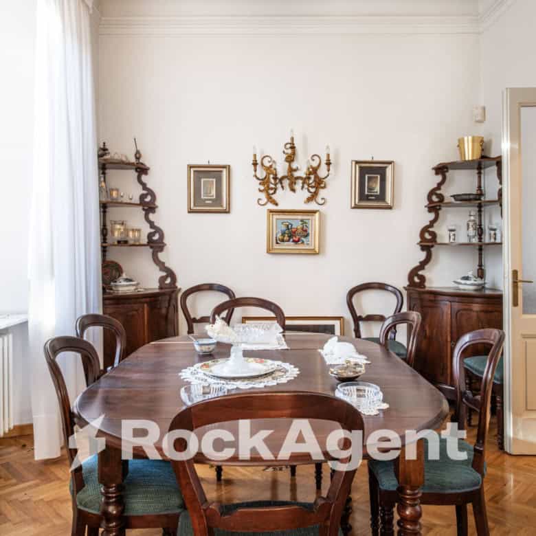 Elegant dining room in a luxury villa in Varzi, Italy, featuring classic wooden furniture and vintag.