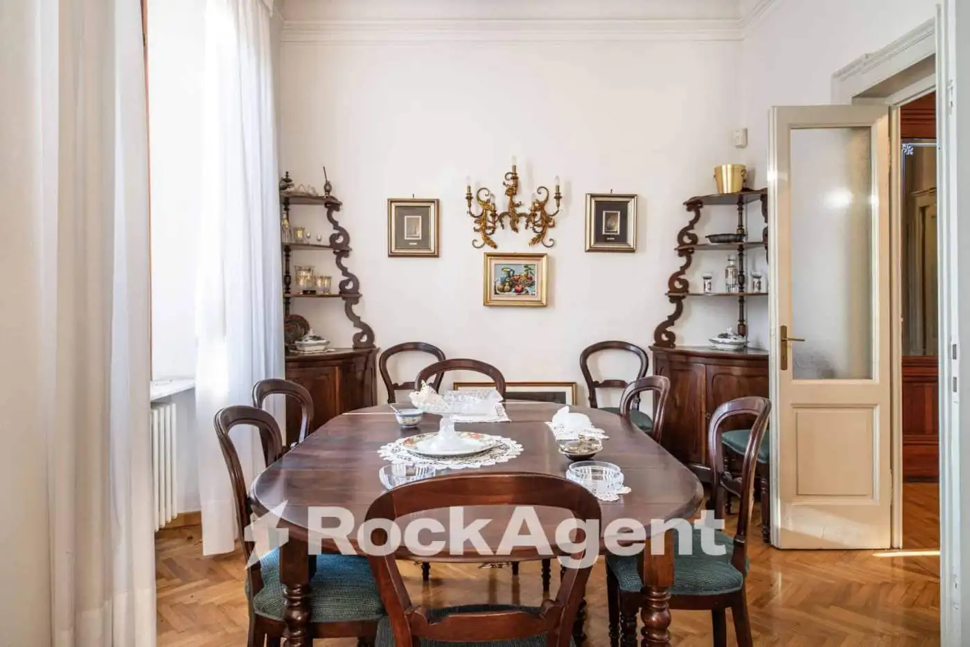 Elegant dining room in a luxury villa in Varzi, Italy, featuring classic wooden furniture and vintag.