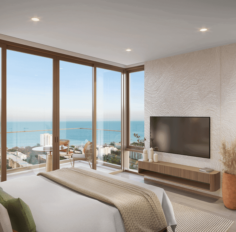 Luxurious living room with panoramic ocean views and floor-to-ceiling windows in Hua Hin, Thailand.
