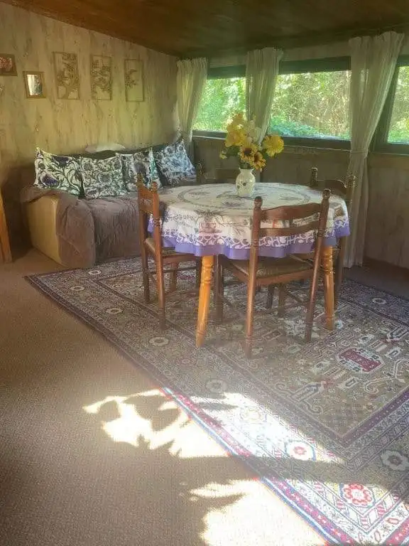 Charming interior of a 4-bedroom country house in Traykovo, Bulgaria, featuring a wooden dining tabl.