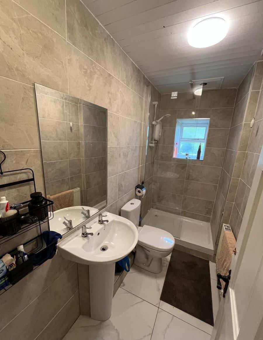 Bright Irish cottage bathroom with modern fixtures and neutral tile decor.