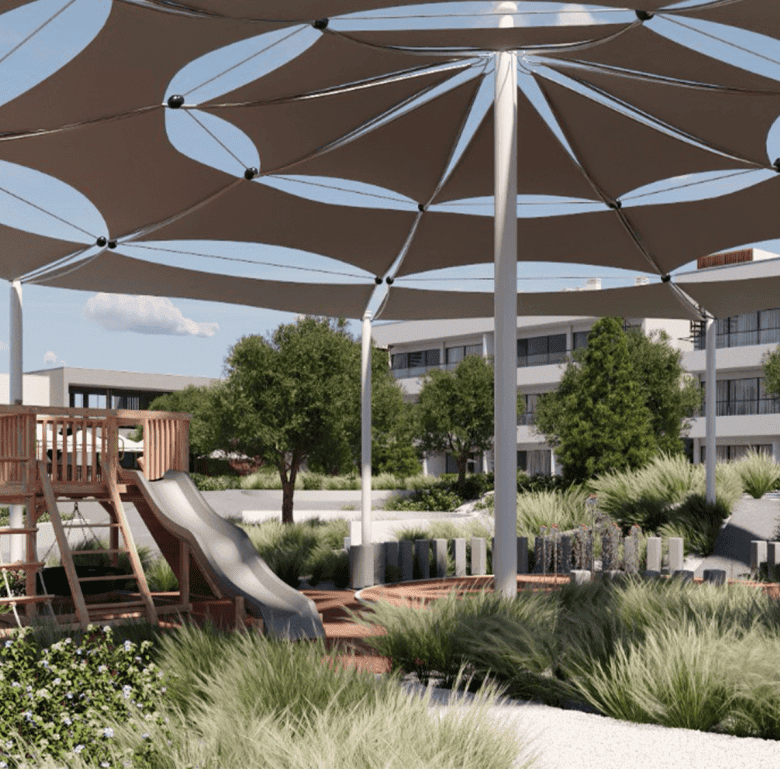 Outdoor shaded play area with large umbrellas and playground equipment in Algarve, Portugal.