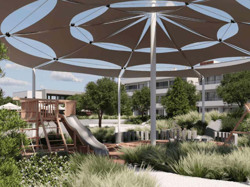 Outdoor shaded play area with large umbrellas and playground equipment in Algarve, Portugal.