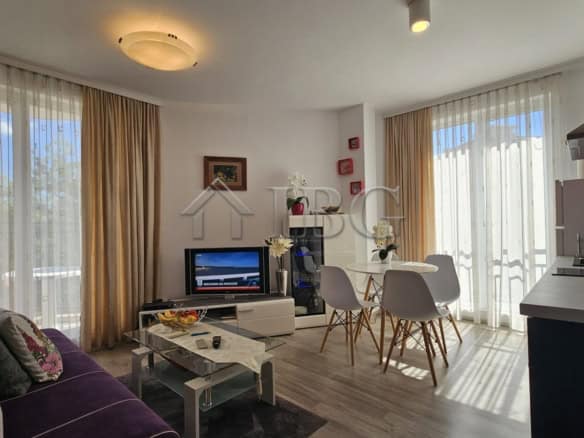 Bright living room with large windows and sea views in Sunny Beach. Modern furnishings and open-plan.