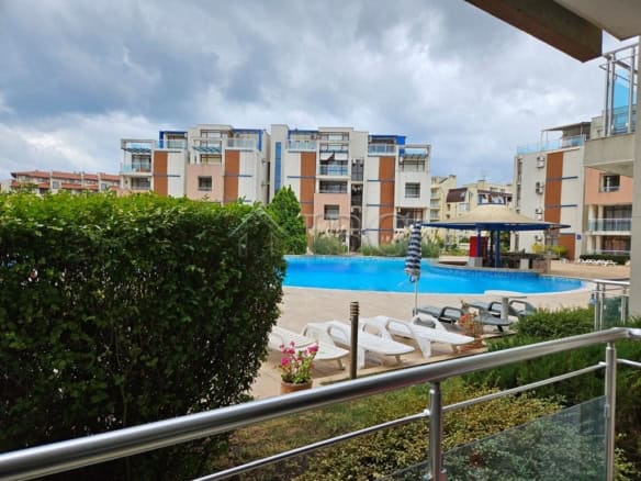 Pool view from studio balcony in Sun City 1, Sunny Beach, with modern amenities and nearby residenti.