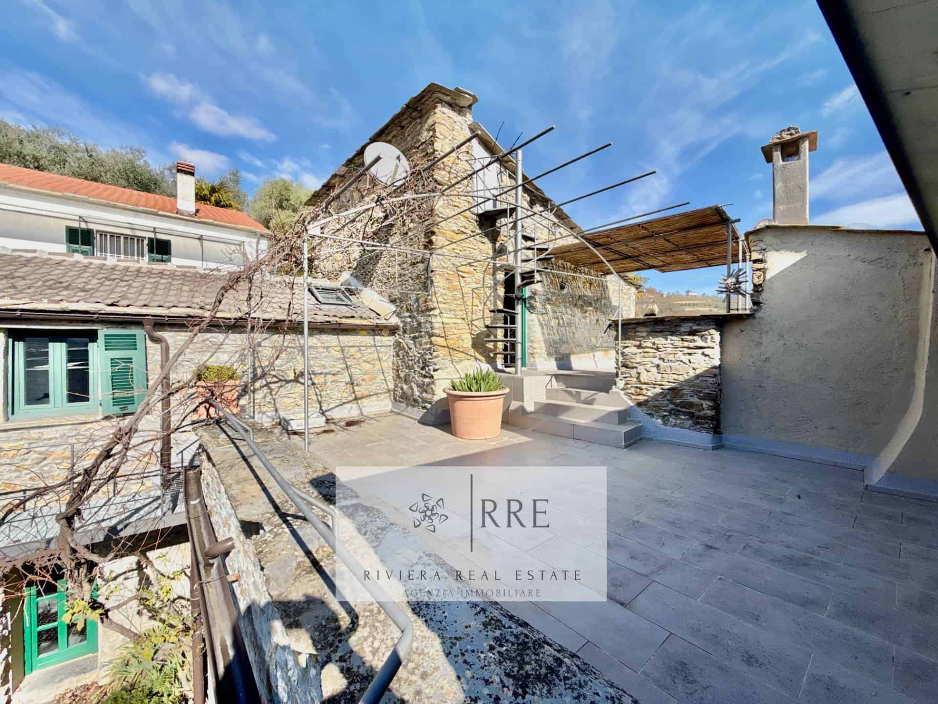 Beautiful stone terrace overlooking historic buildings and lush landscape. Perfect for relaxing or e.