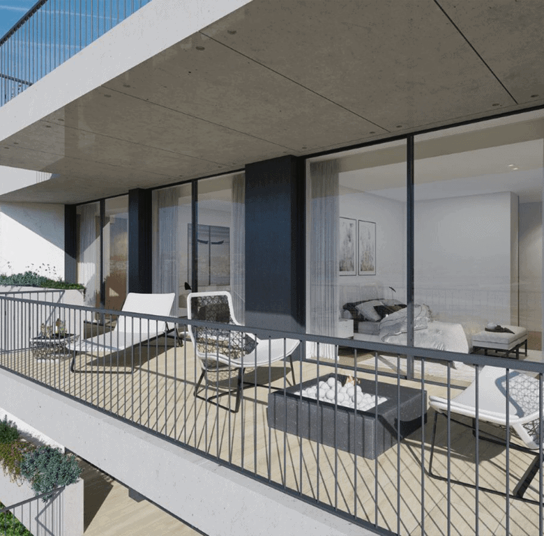 Contemporary balcony overlooking Porto's sea with outdoor seating and glass railing.