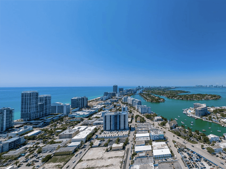 Beautiful aerial view of North Beach Miami with high-rise buildings and ocean in the background.