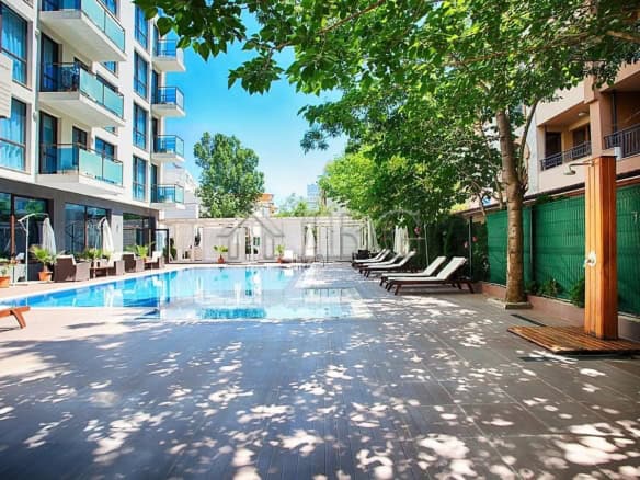 Spacious outdoor pool area with sun loungers and shaded seating in Sun Gate, Sunny Beach.