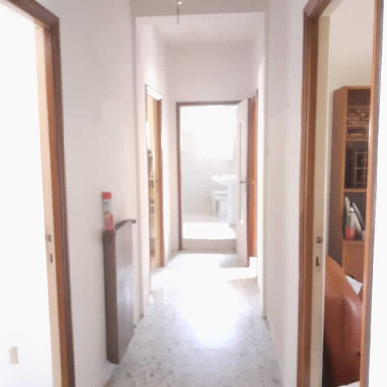 Interior view of a renovated 3-bedroom apartment hallway in Calangianus, Sardinia, Italy.
