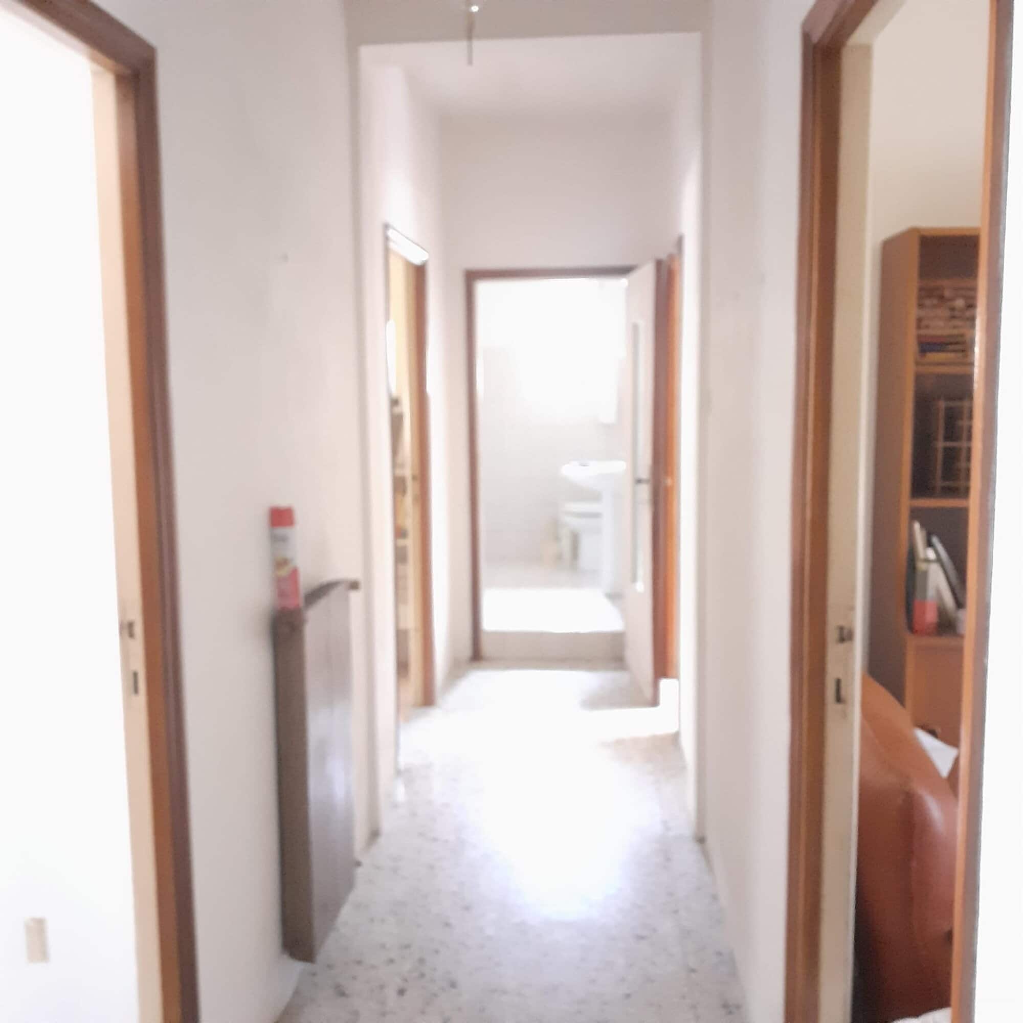 Interior view of a renovated 3-bedroom apartment hallway in Calangianus, Sardinia, Italy.