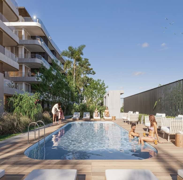 Rooftop pool at Casa Rambla in Montevideo, Uruguay, with residents enjoying the sunny day.