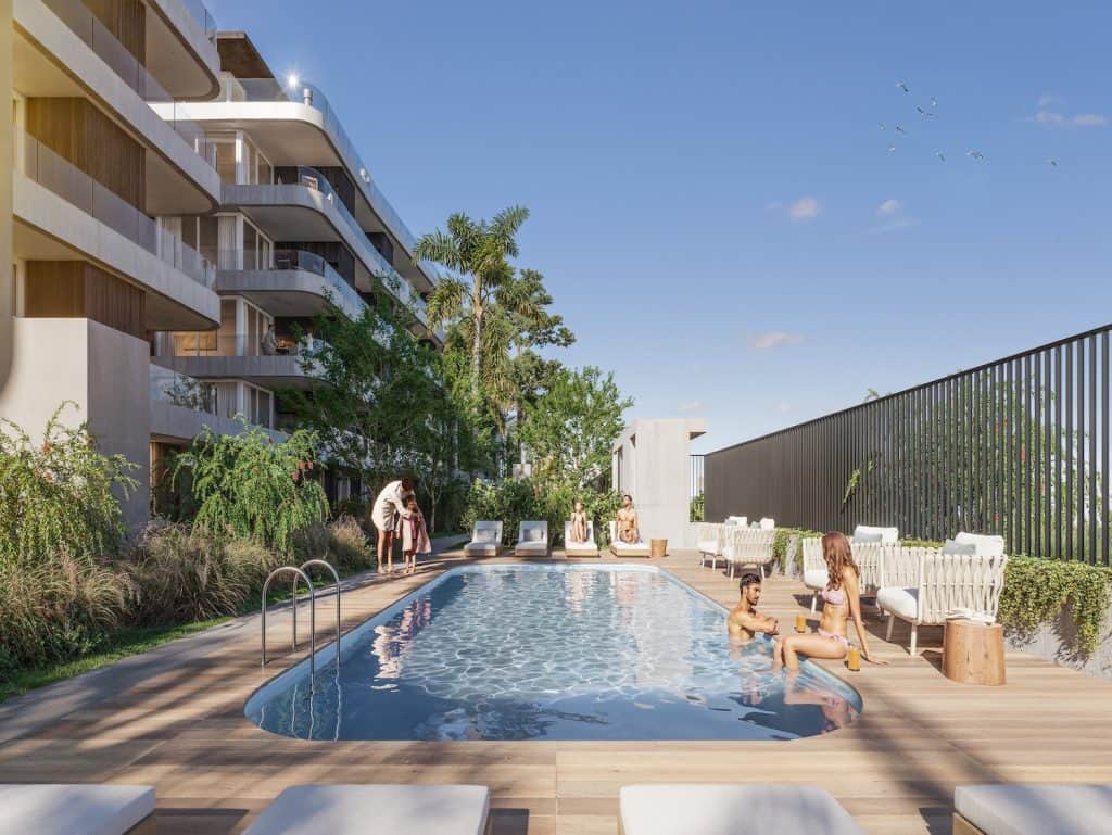 Rooftop pool at Casa Rambla in Montevideo, Uruguay, with residents enjoying the sunny day.