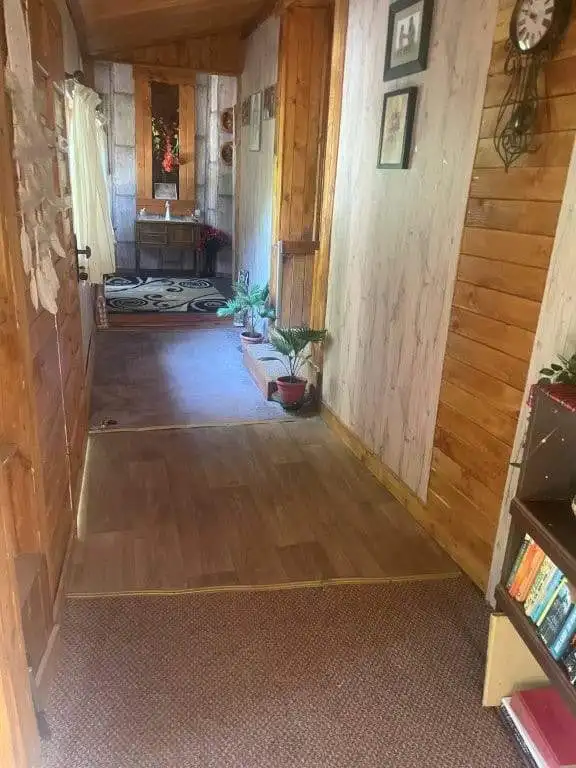Interior view of a cozy 4-bedroom country house in Traykovo, Bulgaria, showcasing wooden walls, deco.