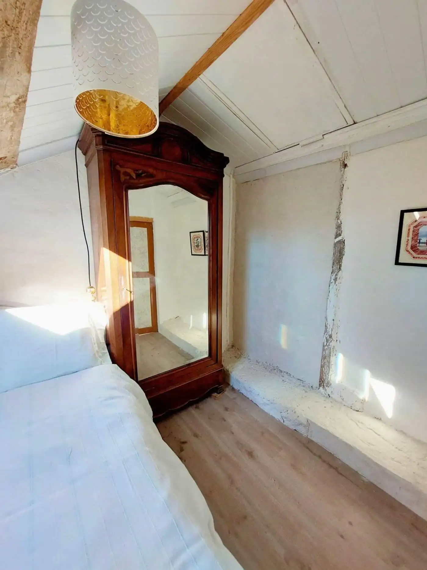 Charming Bedroom in French Farmhouse Beautiful bedroom with floral bedding in a traditional French farmhouse setting.