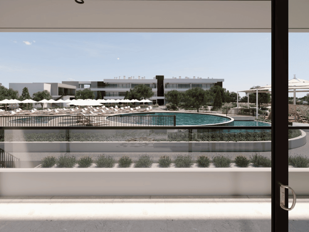 View of a luxurious swimming pool and modern apartments in Algarve, Portugal.
