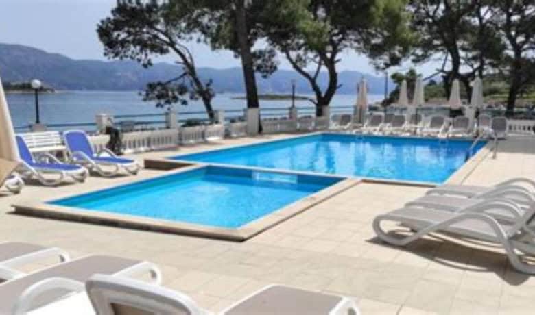Poolside view of a luxury 2-bedroom apartment in Lumbarda Resort, Korčula, Croatia.