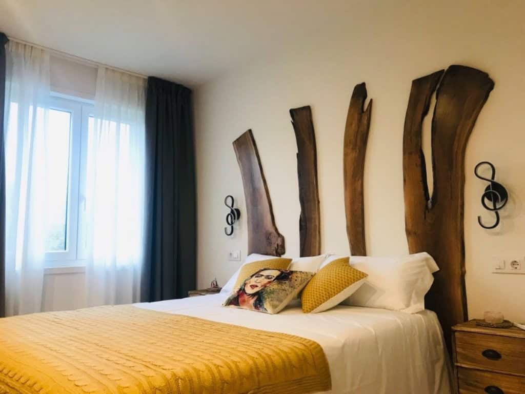 Luxury Finca Vivaldi Hotel Bedroom Elegant hotel bedroom with rustic wooden headboard in Leon, Spain.