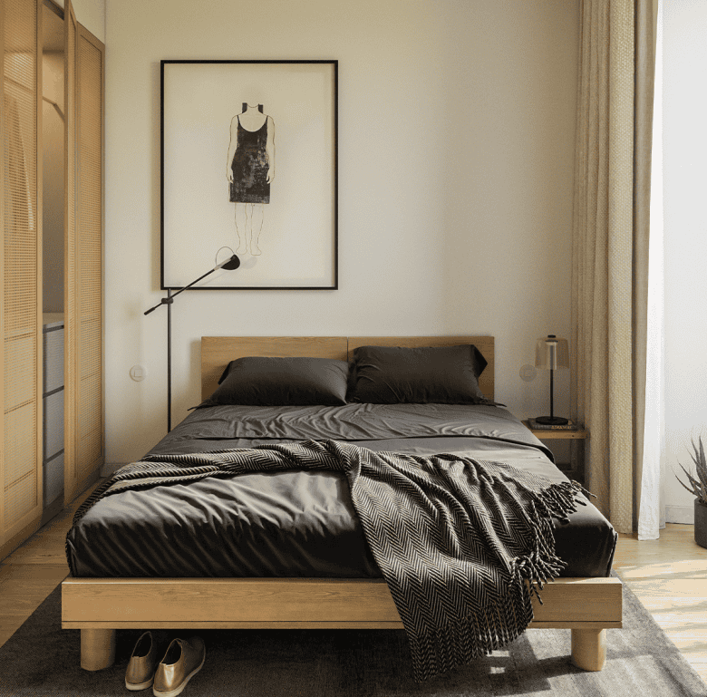 Bedroom with black bedding, wooden furniture, and artwork in Lisbon, Portugal.