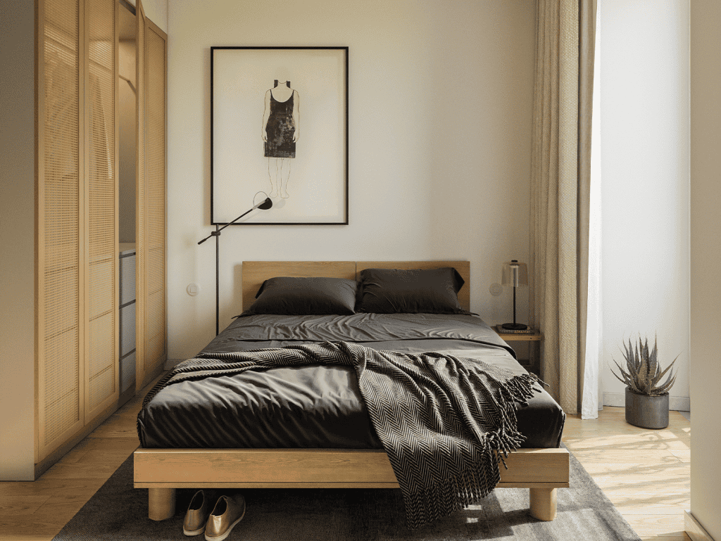 Bedroom with black bedding, wooden furniture, and artwork in Lisbon, Portugal.