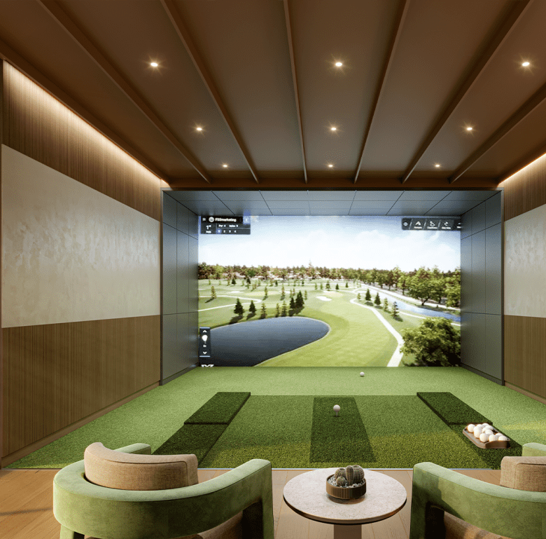 Indoor golf simulation room with large screen and seating area.