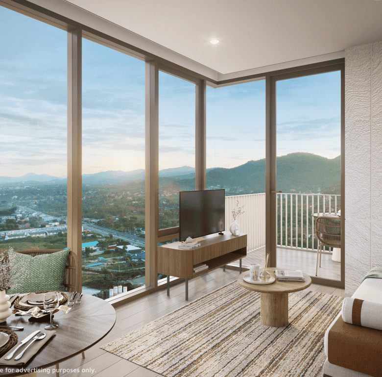 Bright living space with floor-to-ceiling windows showcasing scenic landscape.