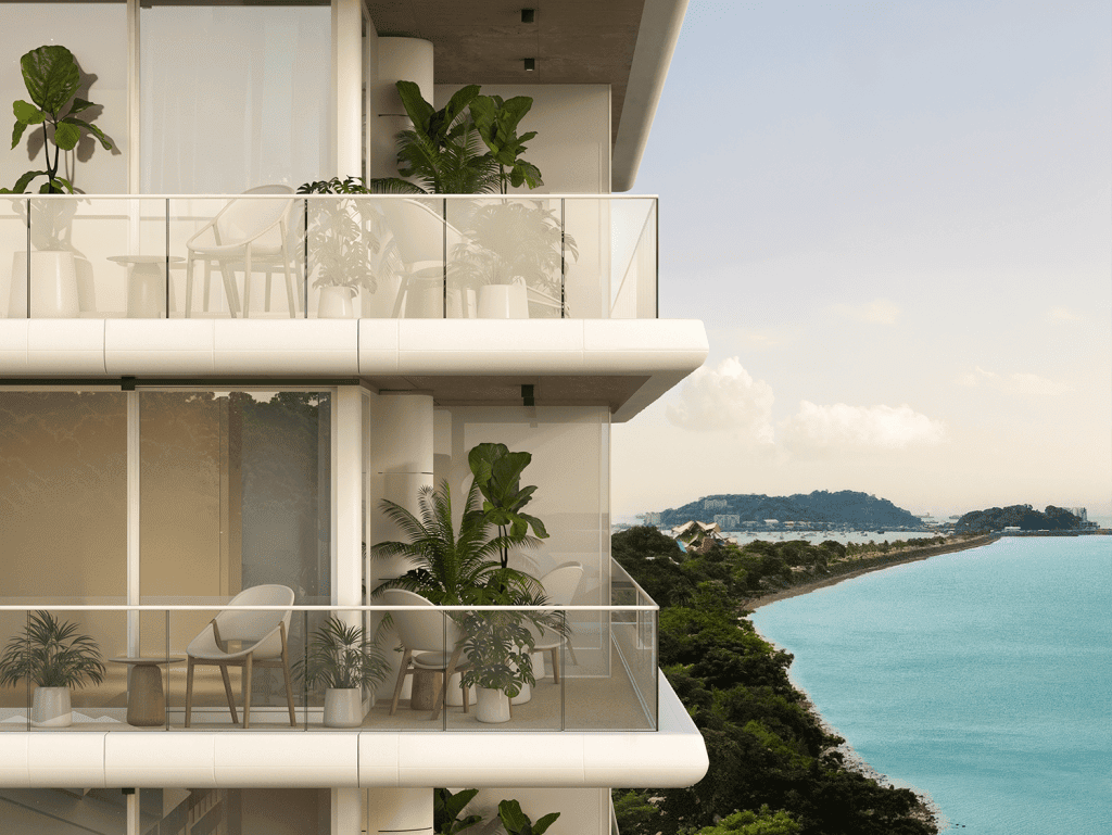 Balcony view of Nautilus residential building in Panama City with lush greenery and ocean backdrop.