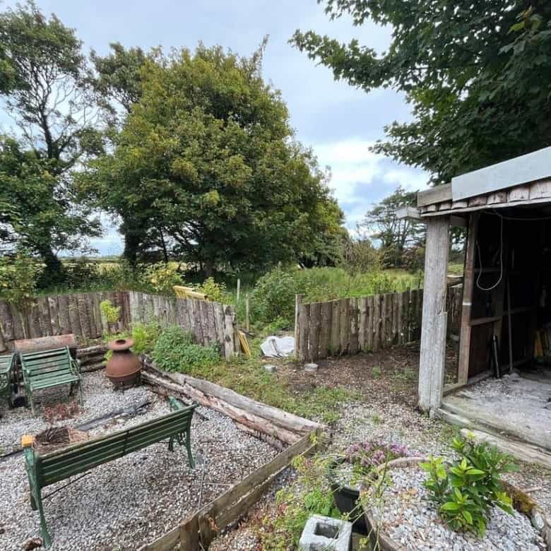 Cozy 2-bed Irish cottage for sale in Farranmacfarrell, Ballina, County Sligo, featuring a lush garde.