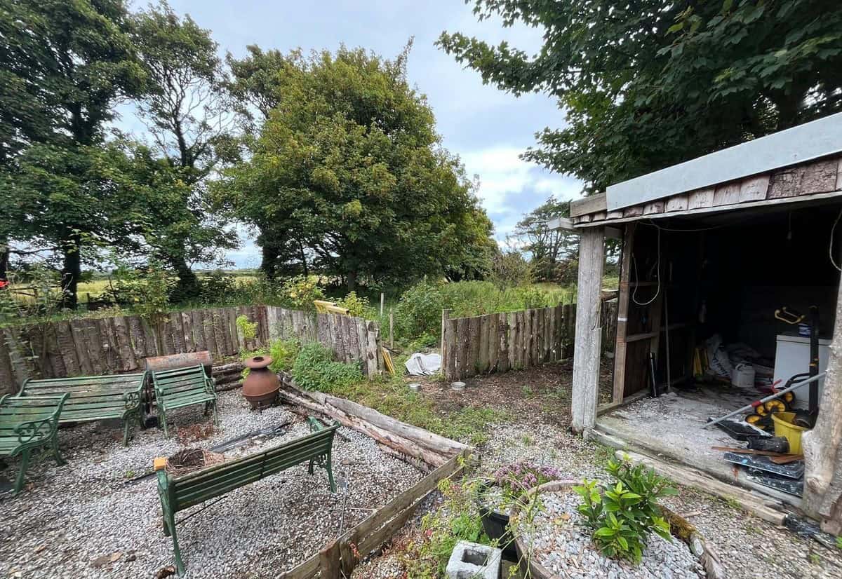 Cozy 2-bed Irish cottage for sale in Farranmacfarrell, Ballina, County Sligo, featuring a lush garde.