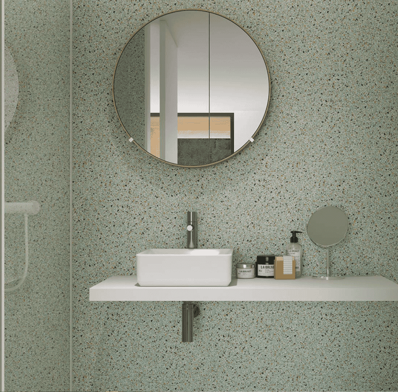 Contemporary bathroom in Porto, Portugal, featuring a sleek sink, round mirror, and minimalist desig.
