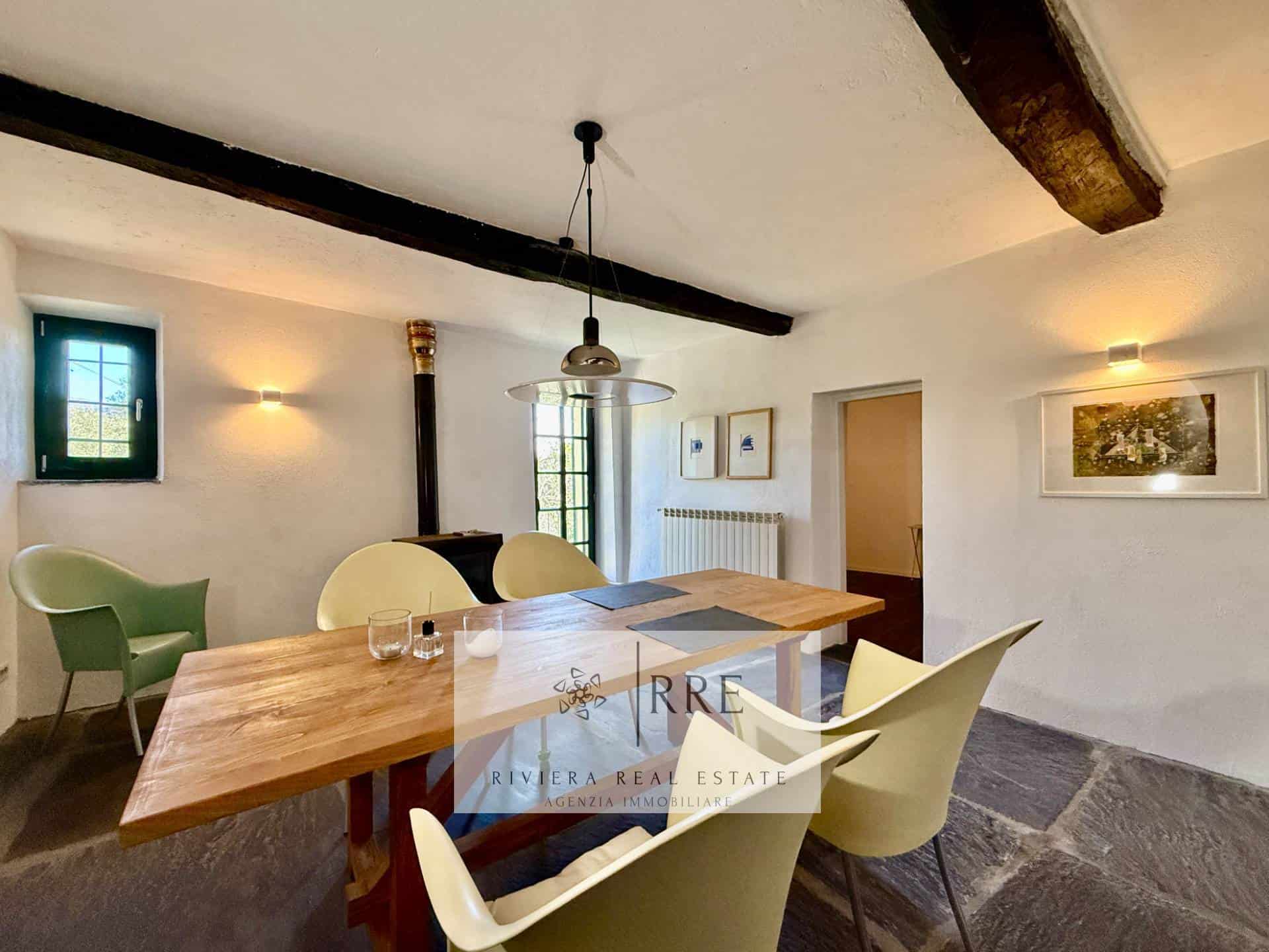 Rustic dining room with wooden beams, modern furniture, and natural light for a cozy home setting.