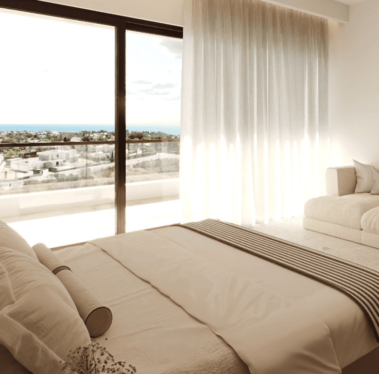 Bright bedroom in Algarve with large window overlooking the sea.