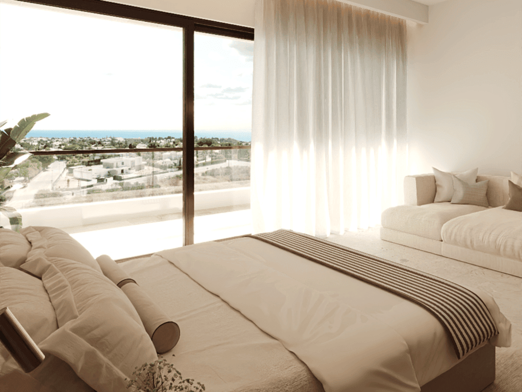 Bright bedroom in Algarve with large window overlooking the sea.