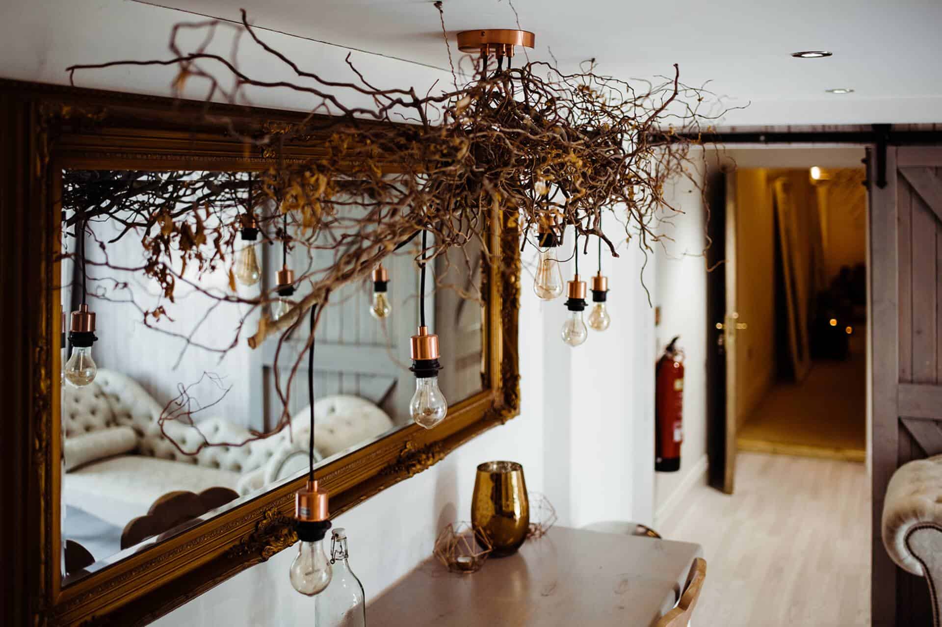 Modern interior with hanging light bulbs and decorative branches Interior decor with hanging light bulbs and natural branch accents.