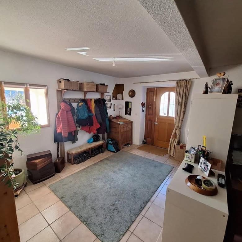 Inviting entrance hall of a renovated village house with wooden accents and cozy decor.