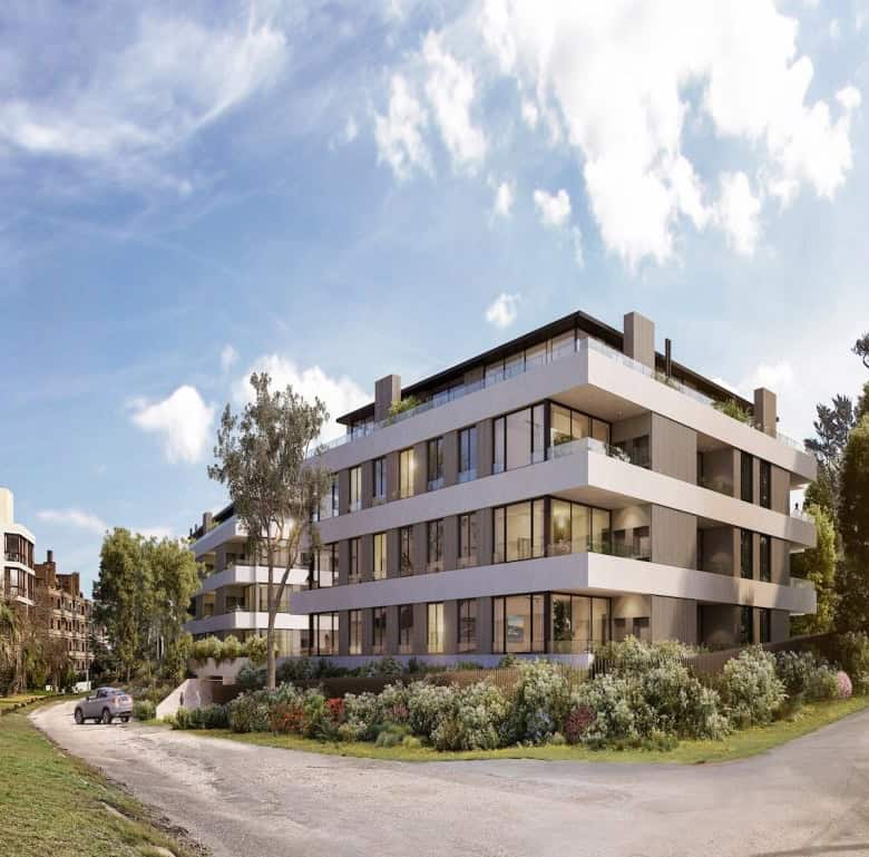Contemporary apartment building in Punta del Este, Uruguay with lush landscaping.