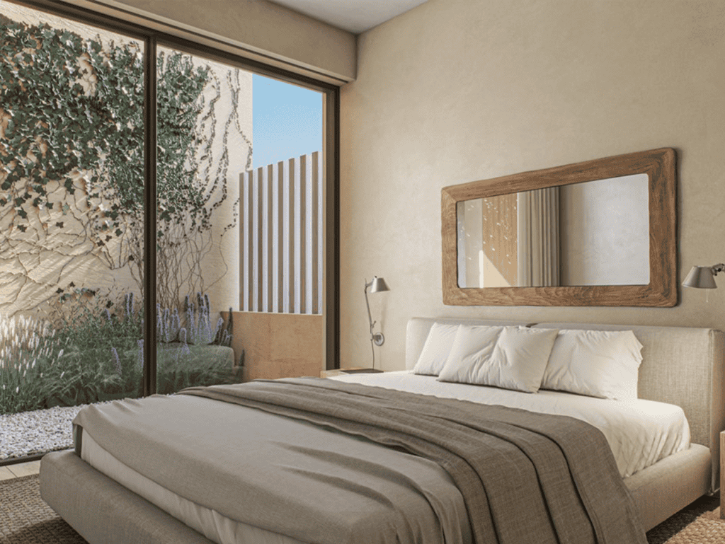 Spacious bedroom featuring a large window with garden views, modern decor, and natural light in Port.