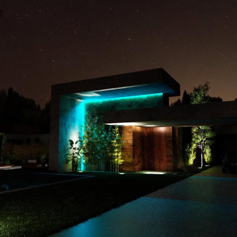 Night view of a modern villa with illuminated exterior lighting in Setubal, Portugal.