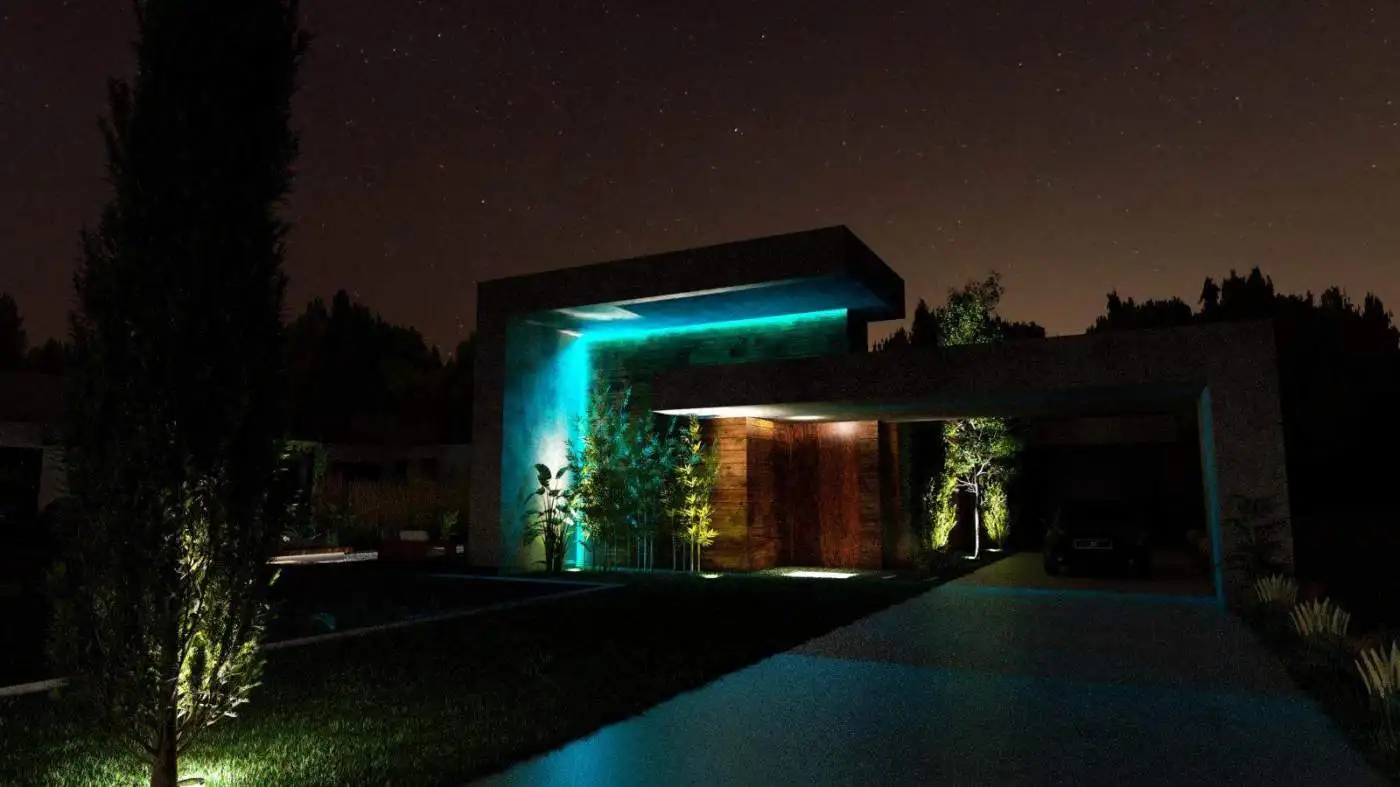 Night view of a modern villa with illuminated exterior lighting in Setubal, Portugal.