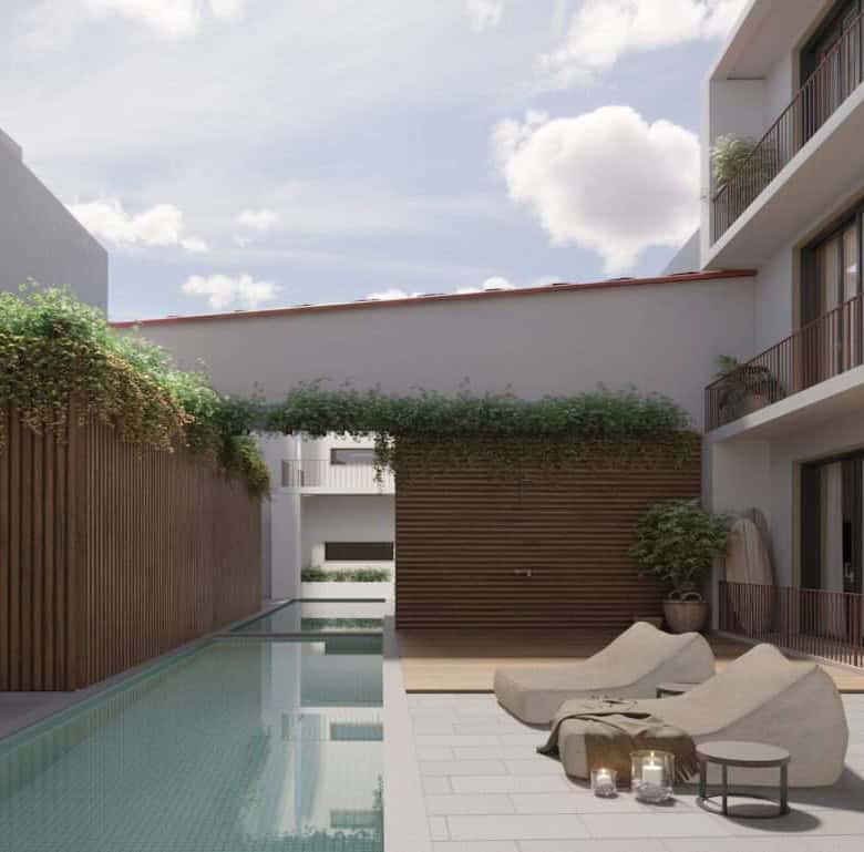 Contemporary apartment terrace with pool and lounge chairs in Peniche, Portugal.