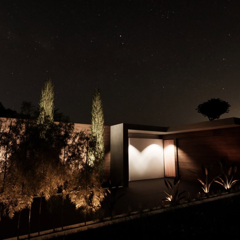Beautiful night view of a modern villa in Setubal, Portugal, illuminated under a starry sky.