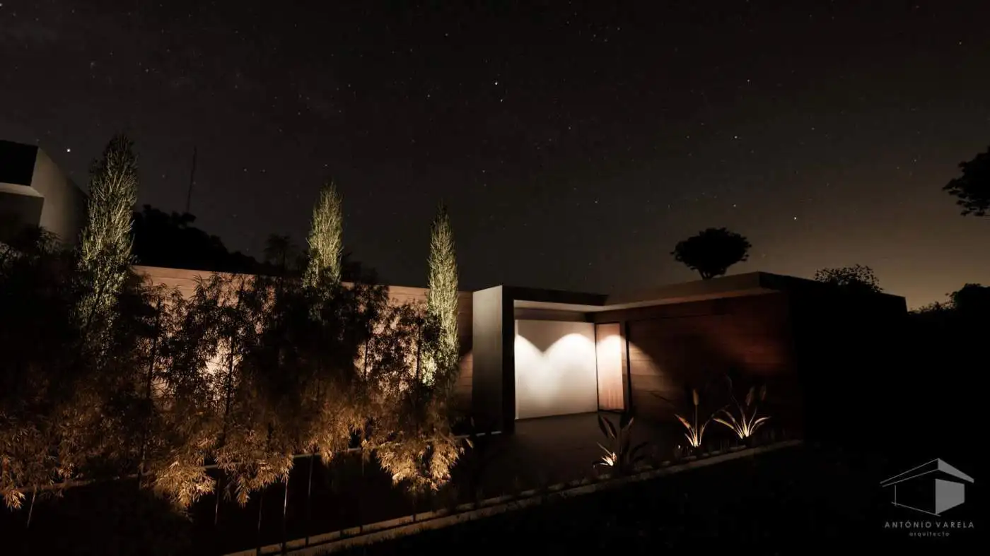 Beautiful night view of a modern villa in Setubal, Portugal, illuminated under a starry sky.