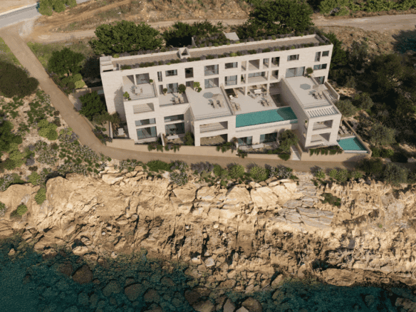 Aerial view of a modern waterfront villa in Kissamos, Crete, with private pools and stunning sea vie.