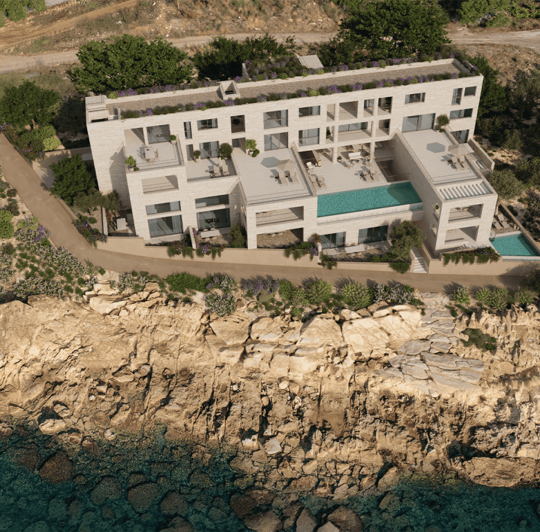 Aerial view of a modern waterfront villa in Kissamos, Crete, with private pools and stunning sea vie.