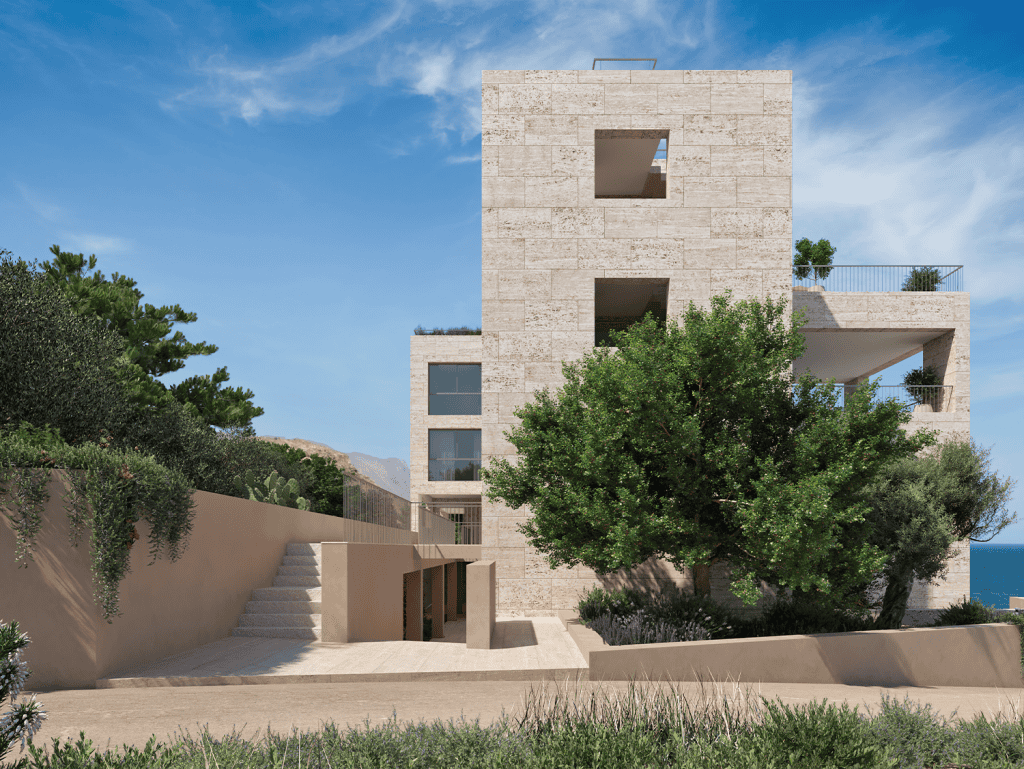 Modern waterfront building in Kissamos, Crete with lush greenery and scenic sea views.
