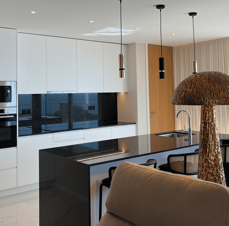 Modern Porto apartment kitchen with sleek design and natural light.