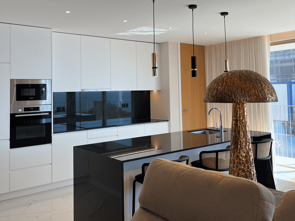 Modern Porto apartment kitchen with sleek design and natural light.